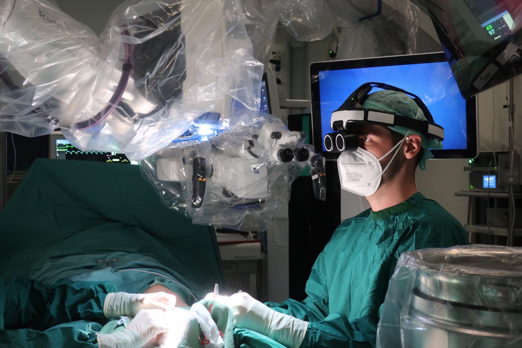 Surgeon performing microsurgical lymphedema surgery under the operating microscope